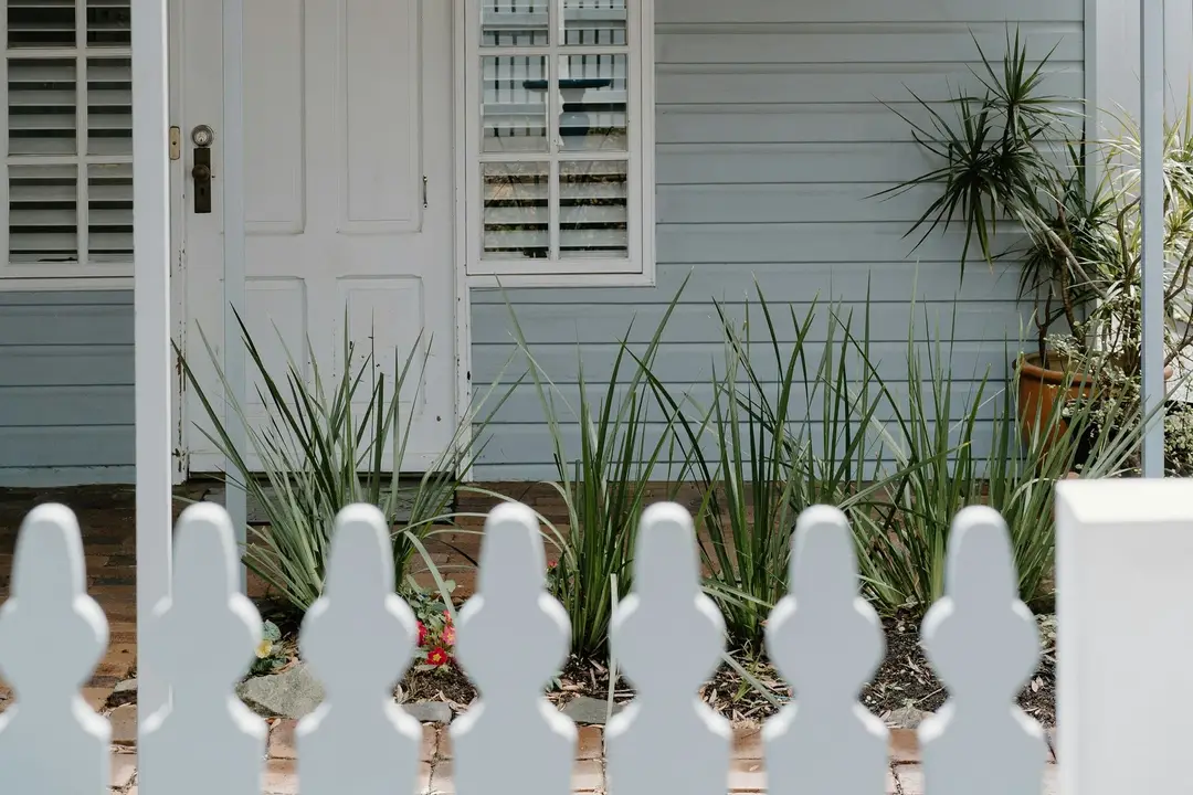 Grey weatherboard cottage with white trims