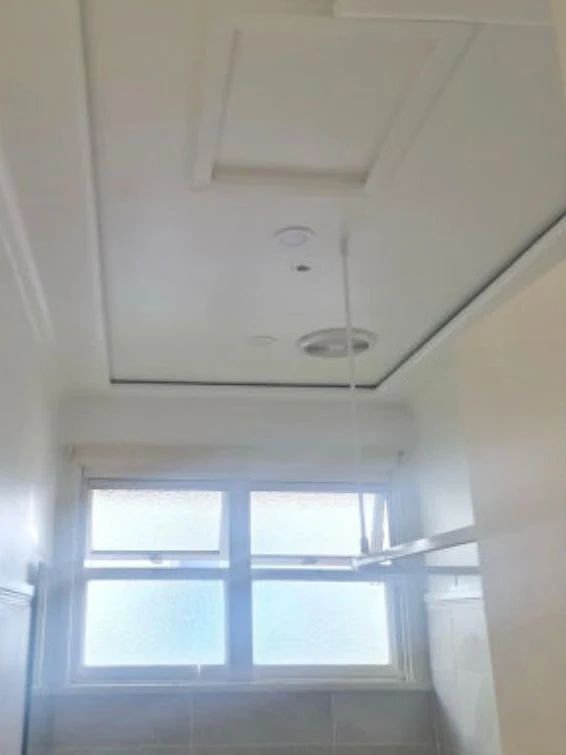 After: Bathroom ceiling, stained and flaking to clean white