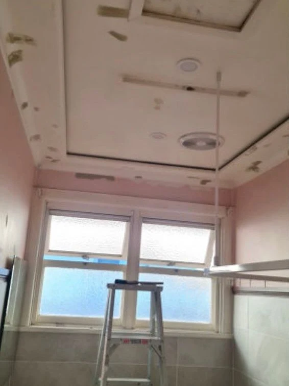 Before: Bathroom ceiling, stained and flaking to clean white