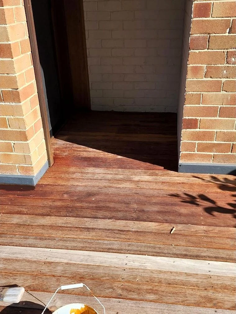 Before: Timber deck, weathered boards to a fresh stained finish